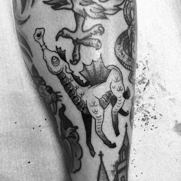 Whimsical seahorse tattoo on leg, featuring a unique blend of surreal and fantasy elements with bold black outlines and creative detailing.