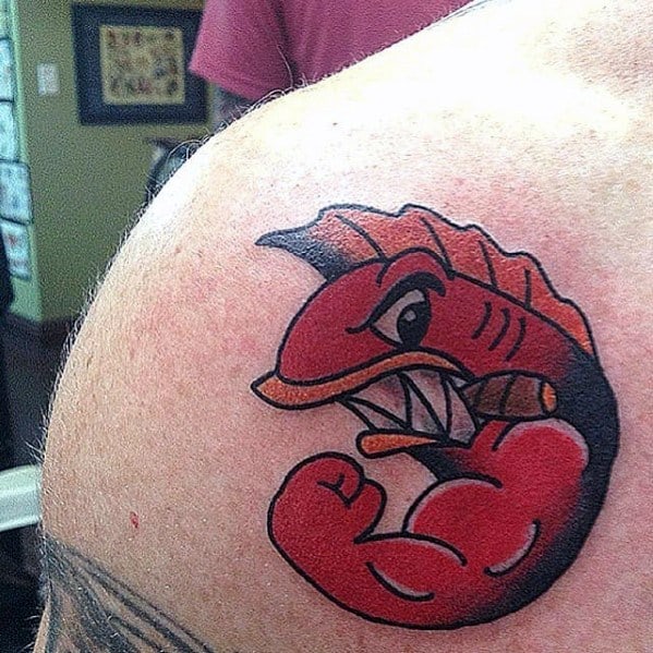 Bold tattoo of the Angry Mutant Fish from The Simpsons, flexing a muscular arm and biting a cigar in a cartoonish style.