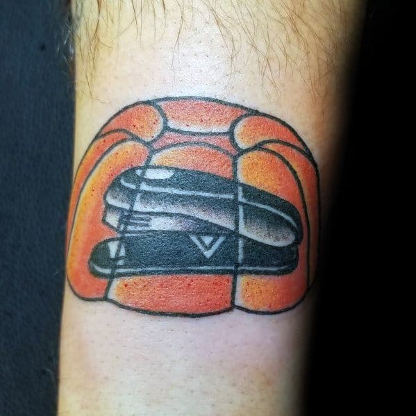 Color tattoo of a black stapler encased in orange Jell-O, referencing Jim’s classic prank on Dwight from The Office.