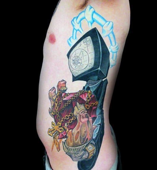 A surreal tattoo of a skeletal hand gripping a hooded figure with a clock for a face, while a chained, flaming heart emerges from within.