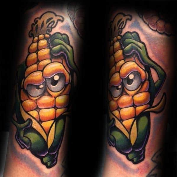 Bold and colorful tattoo of an animated corn cob with expressive eyes and playful features, creating a fun and lively design.