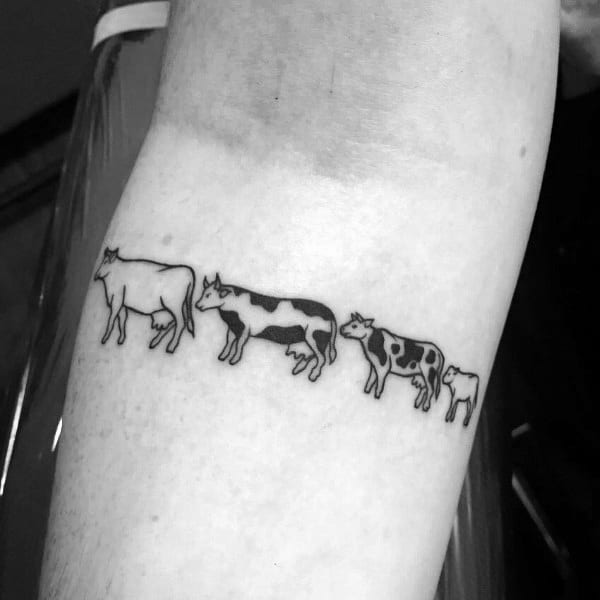 Minimalist cow evolution tattoo showing a sequence of cows in different styles and sizes, inked in a simple black line design.