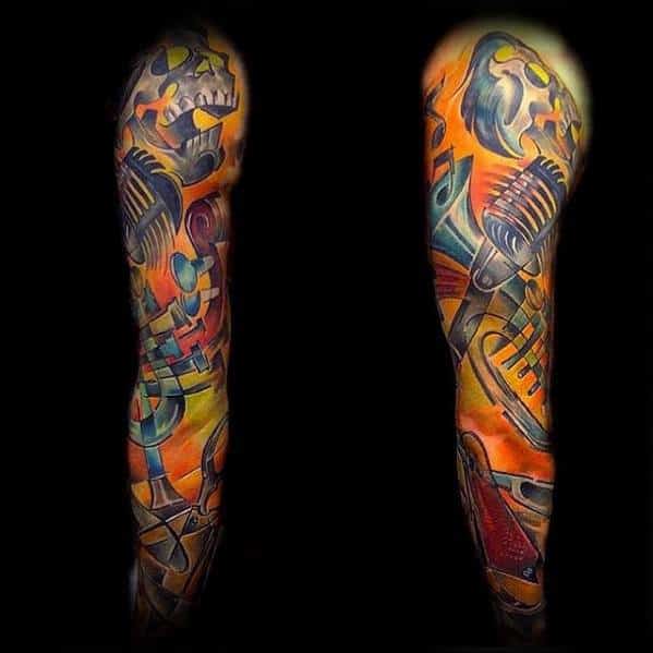 Full sleeve Cubist tattoo with vibrant orange and blue tones, featuring abstract skulls, microphones, and musical instruments.