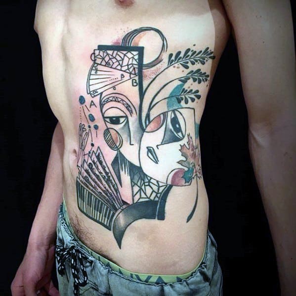 Large Cubist tattoo on the side torso featuring abstract faces, plants, and geometric patterns in soft shades of black, red, and teal.