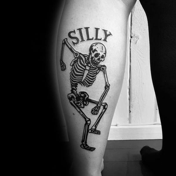 Dancing skeleton tattoo with a playful pose, bold black ink, and the word "SILLY" above, adding a fun and lighthearted touch.