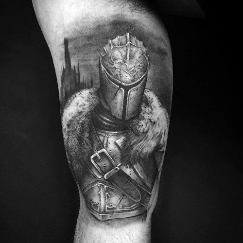 Realistic black and grey tattoo of a Dark Souls knight in fur-trimmed armor, with a dark castle silhouette in the background.