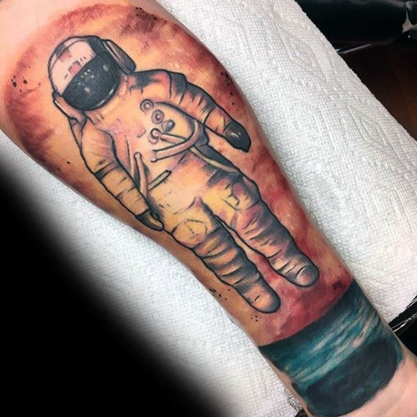 Large Deja Entendu astronaut tattoo with a soft orange sky and teal ocean, capturing a dreamy floating moment in space and time.