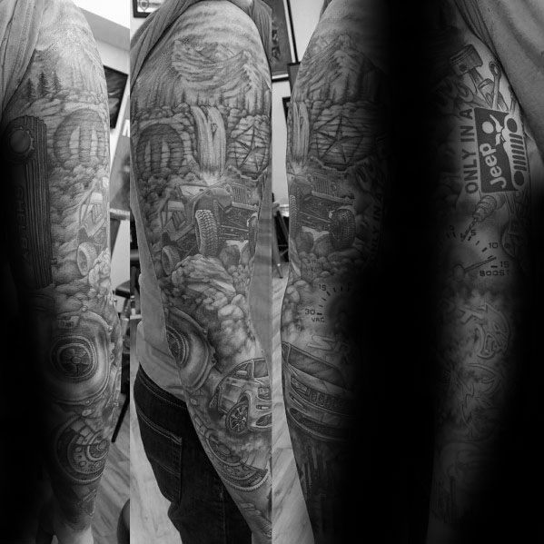 Black and grey Jeep-themed full sleeve tattoo, featuring an off-road Jeep, rugged terrain, mechanical details, and the phrase "Only in a Jeep."