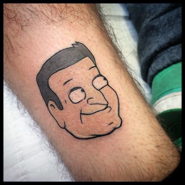 Tattoo of Tom Tucker from Family Guy, featuring his signature confident smirk and strong jawline in a simple black-outlined design.