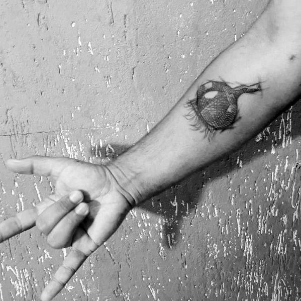 Black and grey garlic tattoo on the forearm with fine dotwork shading, creating a bold and textured botanical design.