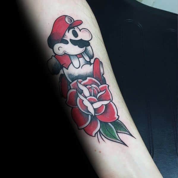 Minimalist Mario tattoo with a classic design, featuring him jumping over a detailed red rose, blending video game nostalgia with traditional tattoo art.