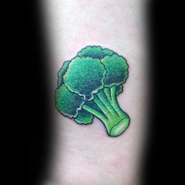 Small realistic broccoli tattoo on the forearm, featuring vibrant green tones, smooth shading, and bold outlines for a crisp and clean design.