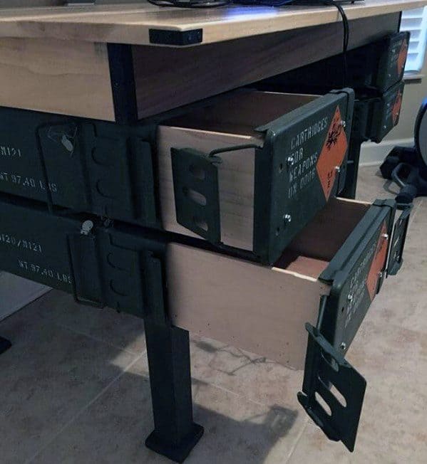 Desk with drawers made from repurposed metal ammo boxes, showing open storage compartments