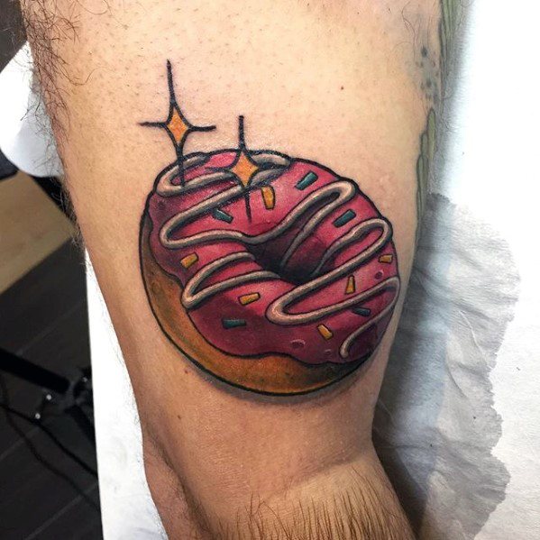 Tattoo of a pink frosted donut with colorful sprinkles, white icing swirl, and sparkle effects for a fun and shiny cartoon style.