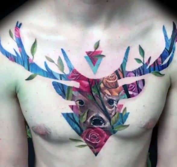 Colorful chest tattoo of a deer’s face and antlers filled with floral and forest patterns, blending nature, symmetry, and geometric shapes.