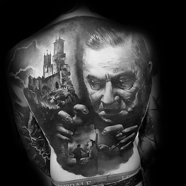 Realistic full back tattoo featuring Dracula’s face, a haunted castle, and eerie silhouettes, symbolizing horror, power, and gothic mystery.