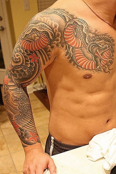 Man with a detailed snake and flower tattoo sleeve on his upper arm and shoulder