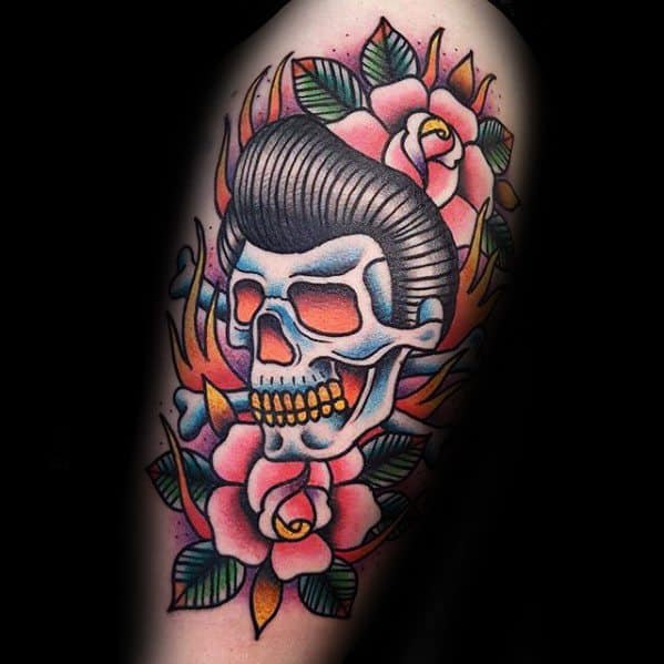 Traditional-style Elvis Presley skull tattoo with bright roses, bold outlines, and a rockabilly vibe, blending beauty with edgy flair.