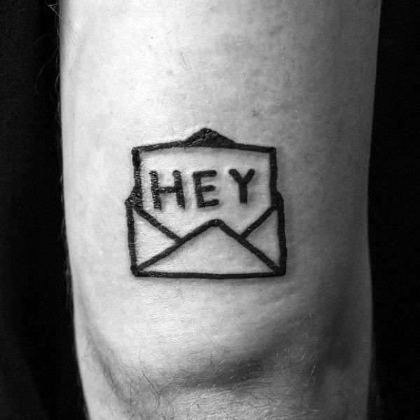 Tattoo of an open envelope with "Hey" inked on a person's skin
