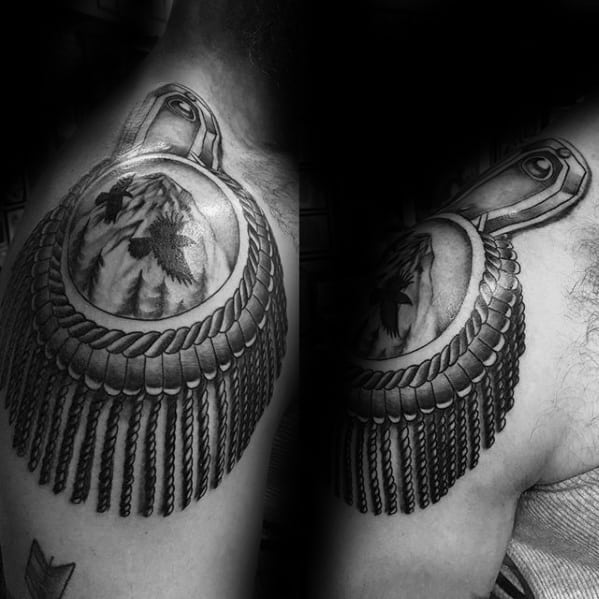 Realistic epaulette tattoo with a detailed wolf portrait at the center, surrounded by braided edges and long rope-like tassels.