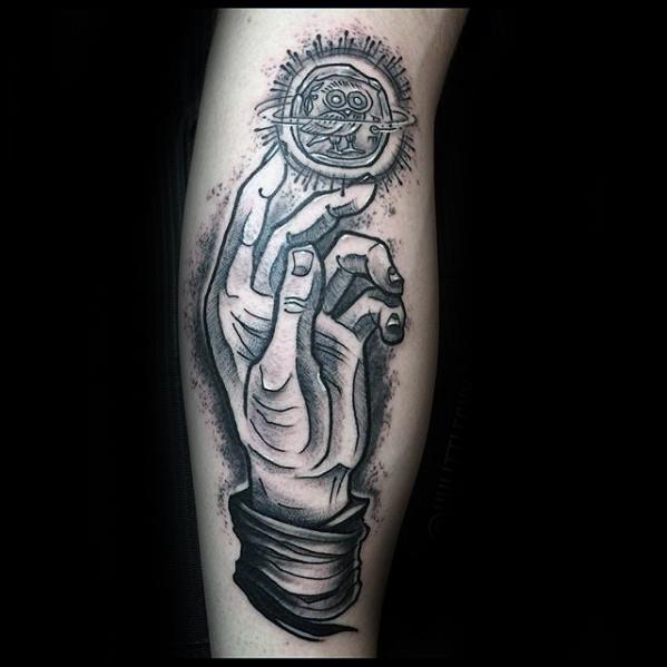 Tattoo of a detailed hand reaching toward a glowing mechanical orb with gears and an eye, radiating energy and mystery.
