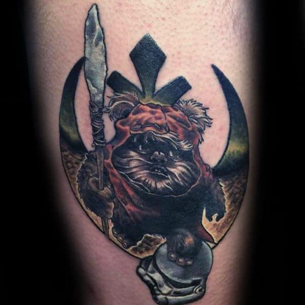 Bold Ewok tattoo standing over a Stormtrooper helmet, with a raised spear and Rebel Alliance symbol in the background.