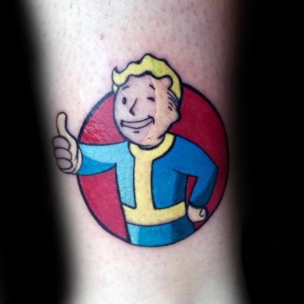 Classic Vault Boy tattoo in a blue and yellow jumpsuit giving a thumbs-up, set against a bold red circular background.