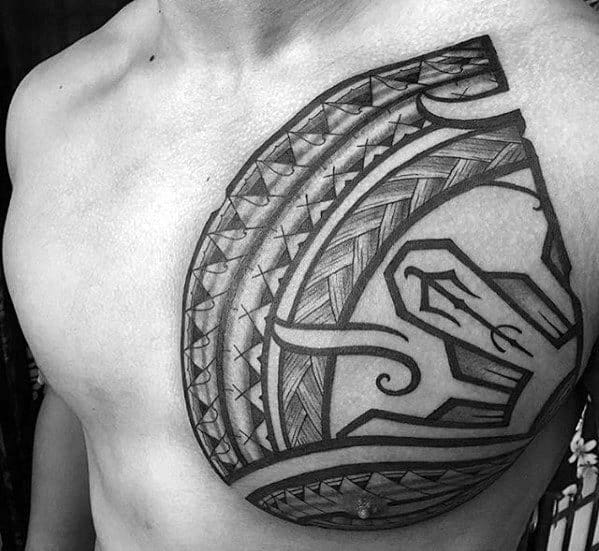 Chest tattoo in Filipino tribal style with bold curves, woven patterns, and intricate linework forming a large crescent-shaped design.