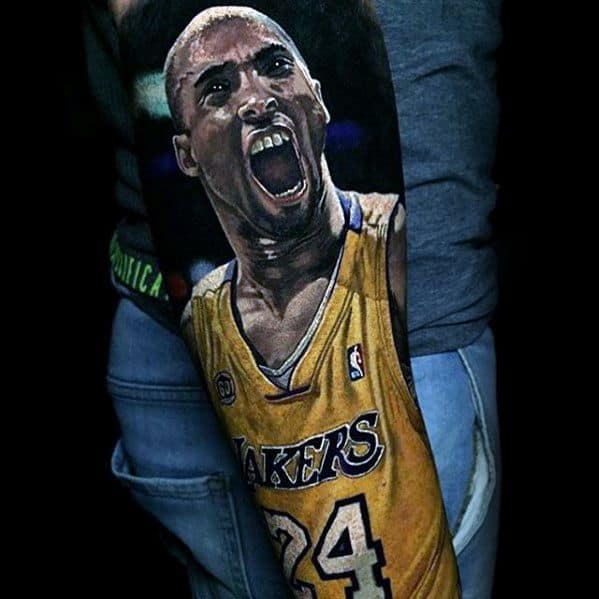 A powerful tattoo of Kobe Bryant passionately yelling in his Lakers jersey, displaying his number 24, capturing his intensity.