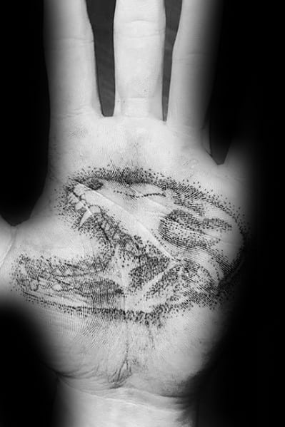 Dotwork palm tattoo of a fox skull with open jaws, crafted with fine stippling for a bold yet delicate skeletal effect.