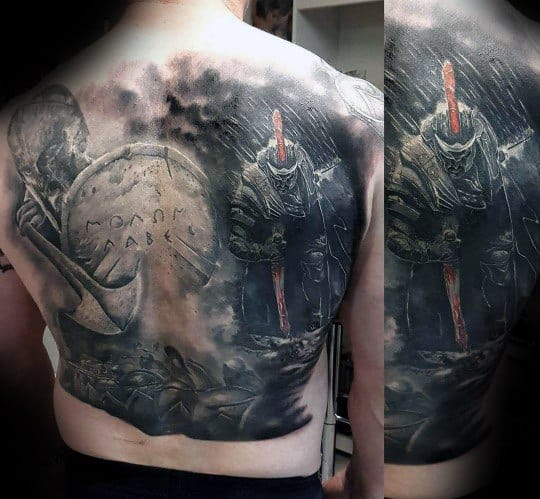 Dark and dramatic full back tattoo of Spartan warriors in battle, featuring a shield with the phrase "Molon Labe" and red accents on helmets and weapons.