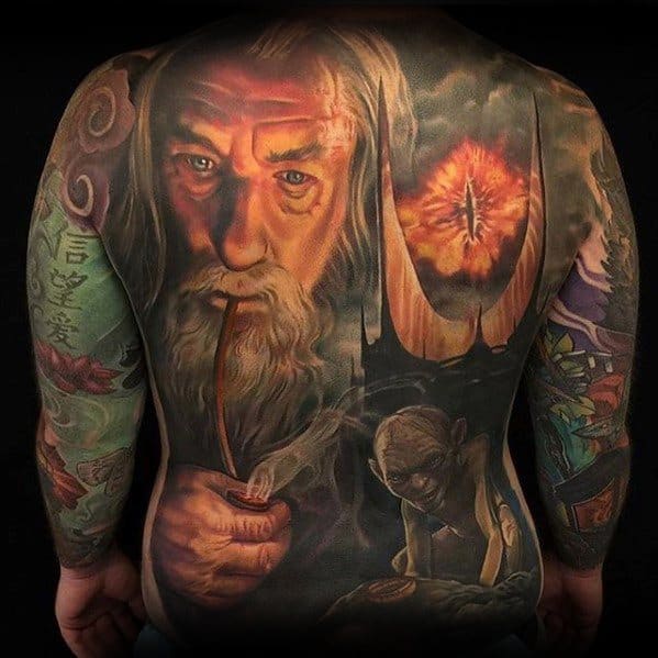 Back tattoo featuring a wizard, Eye of Sauron, and creature with ring in fantasy art style