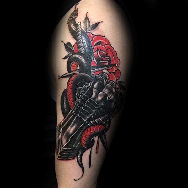 Striking tattoo of a black armored gauntlet gripping a red snake, surrounded by a red rose and dripping blood details.