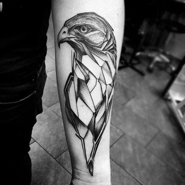 Geometric hawk tattoo on the forearm, blending realistic details in the head with sharp angular body shapes for a fierce, modern style.