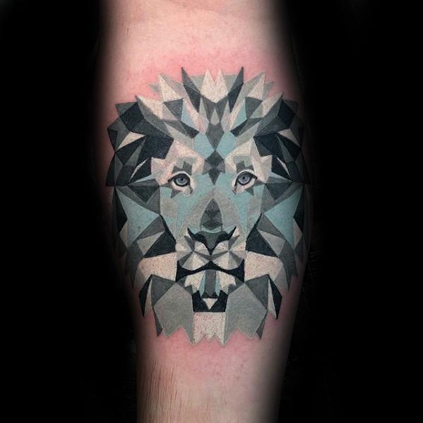 Colorful geometric lion tattoo with layered polygonal shapes in shades of grey, black, and blue, forming a bold and majestic face.