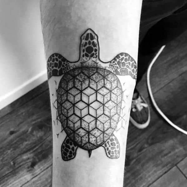 Geometric turtle tattoo on the forearm featuring a hexagonal pattern shell with dotwork shading and realistic detailing on the flippers and head.