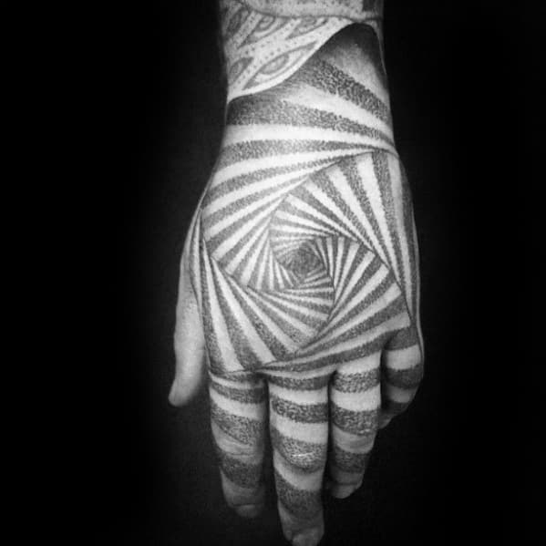 Hand with an intricate geometric spiral tattoo covering the entire hand and fingers