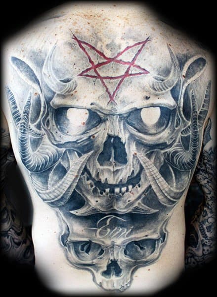 Full-back tattoo featuring a demonic skull with large horns, glowing eyes, and a red pentagram above, creating a dark and gothic aesthetic.