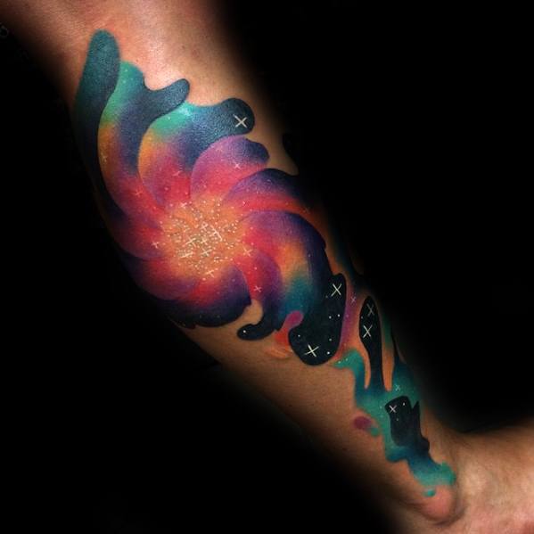 Vibrant galaxy tattoo with a swirling nebula in pink, orange, purple, and teal gradients, filled with stars and cosmic patterns.
