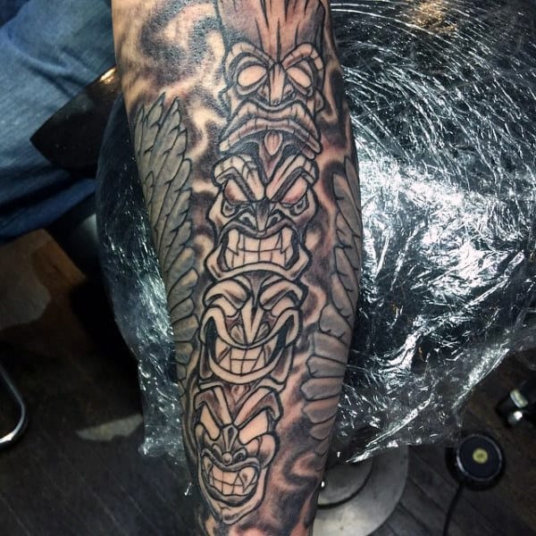 Guys Grining Totem Pole Forearm Tattoo