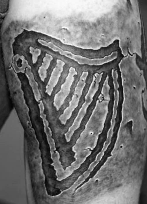 Guys Harp Tattoo Stone Design