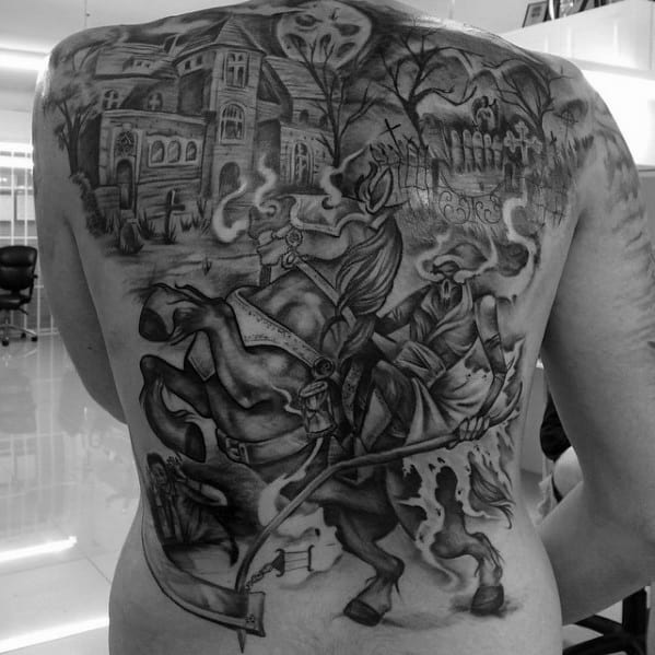 Full back tattoo of a haunted mansion, graveyard, and ghostly horsemen riding through smoke with a scythe under a spooky moonlit sky.