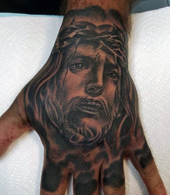 Guys Heavily Shaded Tattoo Of Jesus Christ On Hand
