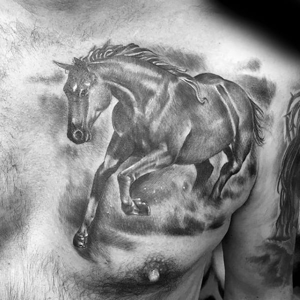 Realistic black and grey tattoo of a galloping horse across the chest, with detailed muscle shading and a smoky background effect