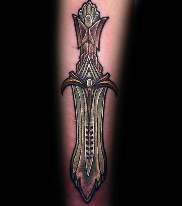 Tattoo of an ornate Skyrim sword with intricate details on a person's forearm