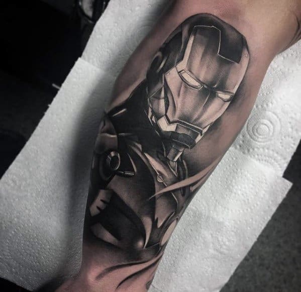 Iron Man tattoo in black and gray shading, showcasing a detailed portrait of his helmet and upper armor, emphasizing the sleek, metallic design.