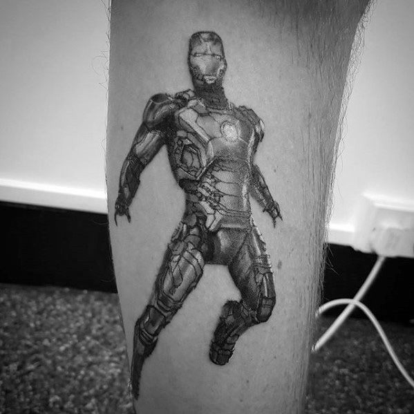 Iron Man tattoo in black and gray, featuring a dynamic action pose of his full suit, capturing the iconic superhero in mid-flight with detailed armor design.