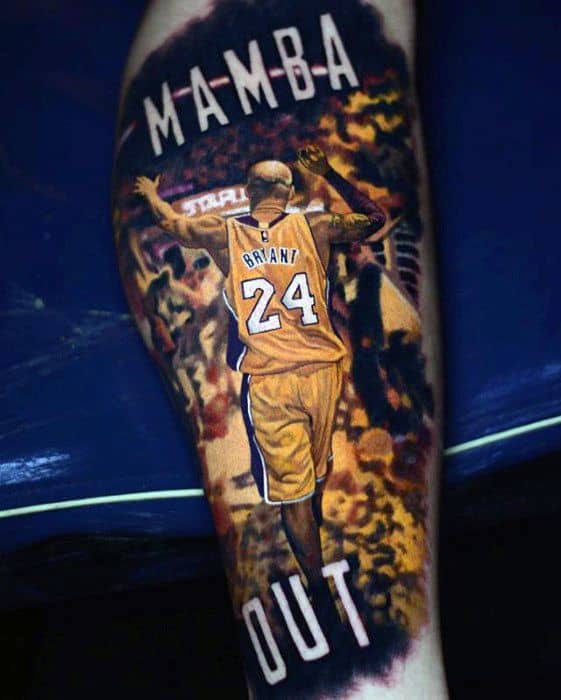 A tattoo of Kobe Bryant with the words "Mamba Out" as he walks off the court, wearing his iconic Lakers jersey with number 24.
