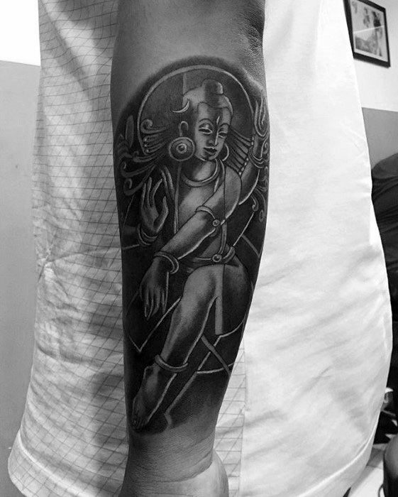 Forearm tattoo of Lord Shiva in a dancing pose with flowing hair and circular backdrop, showcasing dynamic movement and divine energy.