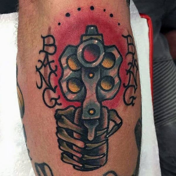 Guys Legs Skeletal Hand With Pistol Tattoo